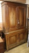 A 19th century French two part oak cupboard W.145cm