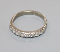 An 18ct white gold and eight stone diamond half eternity ring, size O.