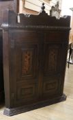 A George III inlaid oak corner cupboard W.105cm