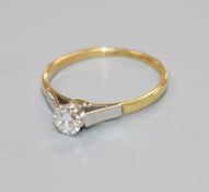 An 18ct gold and platinum set solitaire diamond ring, size M.
