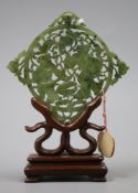 A 19th century Chinese spinach green jade plaque, wood stand H.12cm