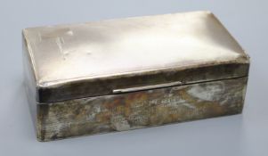 A 1930's Art Deco engine turned silver cigarette box, with presentation inscription, 17.9cm.