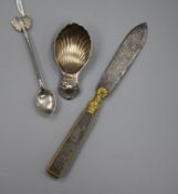 A silver shell caddy spoon, a Ceylonese white metal spoon and a 19th century steel and ormolu letter