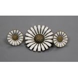 A Danish sterling silver flower brooch and a pair of unmarked similar earrings.