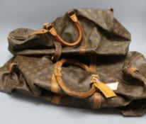 A Louis Vuitton monogrammed holdall and a similar smaller bag