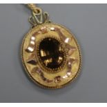 An Austrian yellow metal and gem set oval pendant, 40mm.