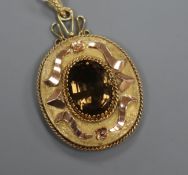 An Austrian yellow metal and gem set oval pendant, 40mm.