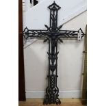 A cast iron black-painted crucifix of openwork foliate form length 104cm