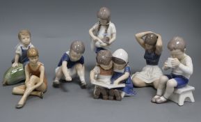 Seven Bing & Grondahl and Royal Copenhagen small figures, including Boy seated on a marrow, No.