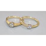 Two yellow metal and solitaire diamond rings.