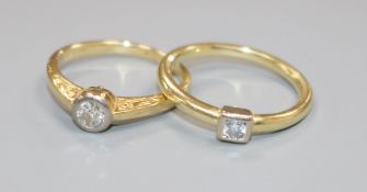 Two yellow metal and solitaire diamond rings.