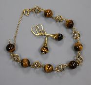 A 585 yellow metal and tiger's eye quartz bead bracelet and a pair of matching earrings.