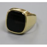 A 585 yellow metal and black onyx signet ring, size T.