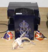 Four boxed Royal Crown Derby paperweights, two unboxed paperweights and a Steuben glass dolphin, the
