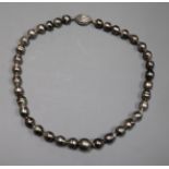 A modern single strand baroque cultured Tahitian? pearl choker necklace with a 14kt white gold and