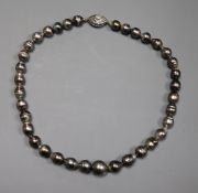 A modern single strand baroque cultured Tahitian? pearl choker necklace with a 14kt white gold and