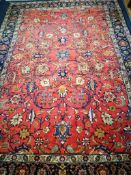 A Persian Heriz red ground rug 310 x 222cm