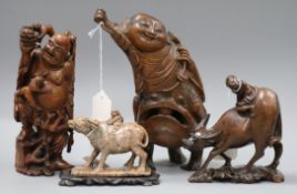 Three Chinese figural wood carvings and a soapstone carving of a child riding a water buffalo, the