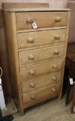 An oak tall chest of drawers W.63cm