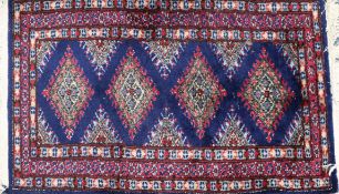 A small blue and red ground rug 100x 60cm