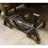 A pair of 17th century style black painted cast iron firedogs, combined with a fire grate W.65cm