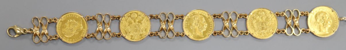 A 585 yellow metal bracelet set with five Austro Hungarian gold coins, 21.5cm.