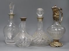 Three cut glass decanters with silver collars (one stopper deficient) and plate-mounted cut glass