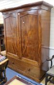 An early Victorian mahogany two door wardrobe, fitted one long base drawer W.154cm