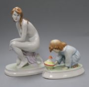 A Zsolnay porcelain figure of a child with spinning top and a kneeling female nude height 22.5cm (