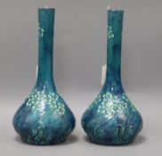 A pair of Liberty & Co long-necked bottle-shaped vases, possibly Burmantofts or Brannam Barum,