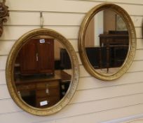 A pair of Victorian oval giltwood and gesso wall mirrors W.54cm
