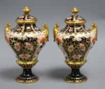 A pair of Crown Derby porcelain miniature urns and covers height 14cm