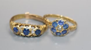 Two early 20th century 18ct gold, sapphire and diamond rings including cluster and half hoop.