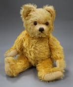 A 1930's Farnell teddy bear, Carol / Carrie, with golden mohair, deep amber and black glass eyes,