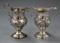 A George III silver cream jug, London, 1818, with later embossed decoration and a similar later