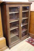 A late Victorian walnut glazed bookcase W.106cm