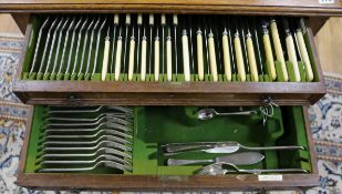 A 1920's Walker & Hall silver plated part canteen contained in an oak two drawer table case