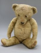 A 1930's Merrythought teddy bear, Theo, with pale blond mohair, deep amber and black glass eyes,