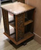 An Edwardian carved oak revolving bookcase W.43cm