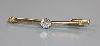A yellow metal and solitaire diamond bar brooch, lacking seed pearl at each end? the stone