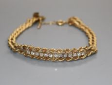 A 14k gold and thirteen diamond set bracelet.