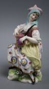 A Chelsea? porcelain figure of a lady Hurdy Gurdy player height 15cm
