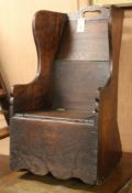 A 19th century oak child's rocking armchair with commode seat