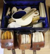 A Victorian maroon moroccan leather dressing case, containing a quantity of ivory brushes, mirror,