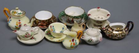 A collection of miniature teawares, including Royal Crown Derby, Worcester, Crown Staffordshire