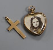 A 9ct. gold mounted heart locket and a 9ct gold cross pendant.