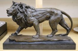 A bronze of a standing lion, on marble base height 29cm