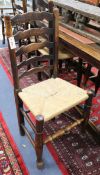 A set of eight oak rush seat ladderback chairs