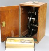 A Baker of London cased microscope and two boxes of slides
