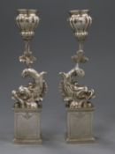 A pair of Italian 800 white metal dolphin candlesticks, on pedestal bases, 23.5 oz.